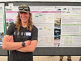 CIRES Graduate Research Assistant Cliff Adamchak,, in Ecology and Evolutionary Biology, poses by his poster at Rendezvous 2025 - Rendezvous 2025