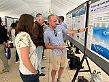 Jake Gristey, CIRES research scientist in CSL, makes a point about his poster at CIRES Rendezvous 2025. - Rendezvous 2025